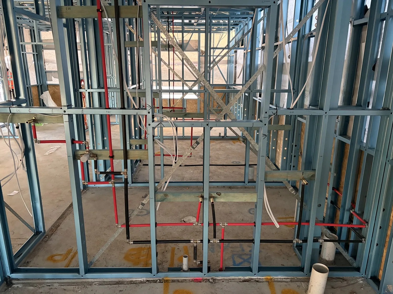 Hot and cold water pipework installed in steel framing